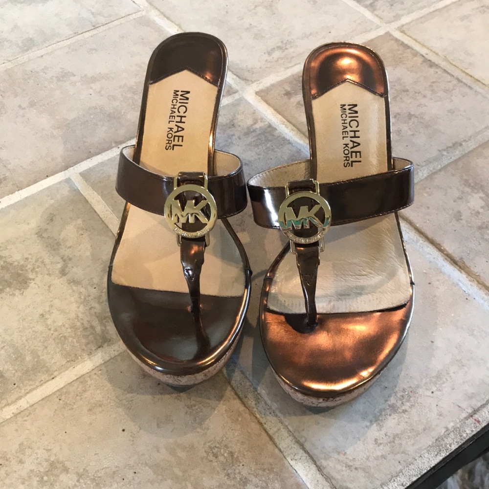 Michael Kors Brown flip flop wedges.